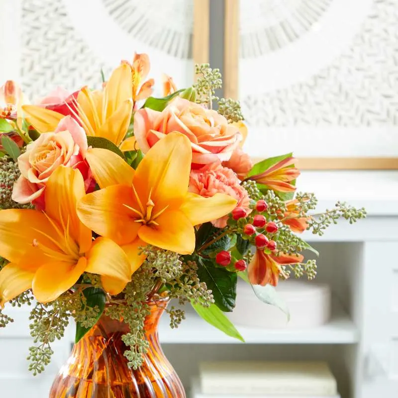 orange bouquet inside an orange vase